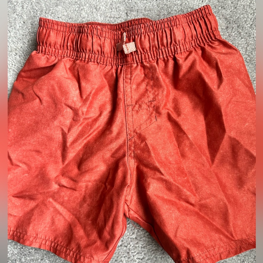 Two pairs of little boy swim trunks